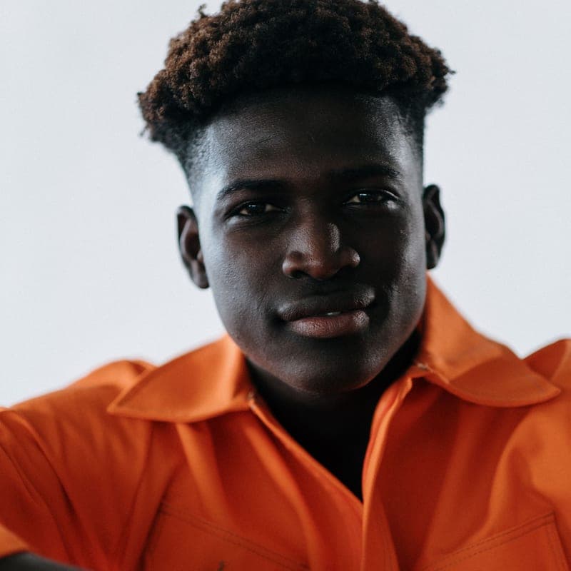Portrait of a smiling man in an orange shirt
